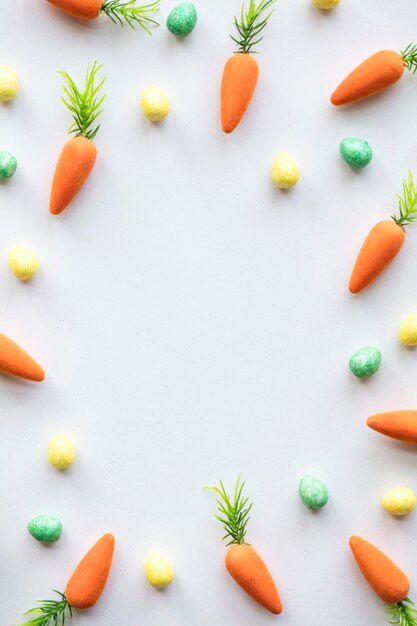 Easter seasonal background with colourful eggs and carrots