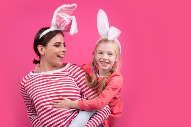 Easter sisters. Happy childhood. Girls with bunny ears. Egg hunt. Traditional spring holiday.