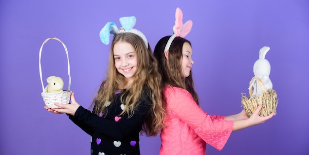 Easter spells out beauty. children holding bunny pets in easter baskets. little girls wearing bunny ears on easter day. small kids with cute bunny toys. easter bunny bringing gifts to happy children