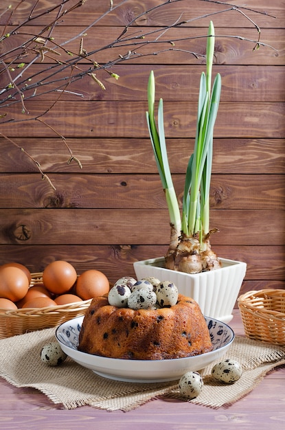 Easter still-life, Easter cupcake, with chicken and quail eggs on a wooden rustic desk background