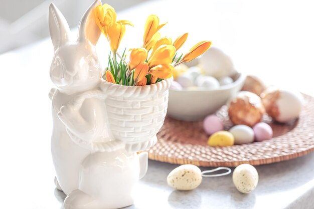 Easter still life with a ceramic hare eggs and flowers