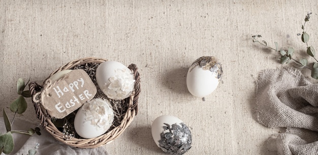 Easter still life with eggs in a wicker basket. Happy Easter concept.