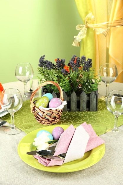 Easter table setting on color background