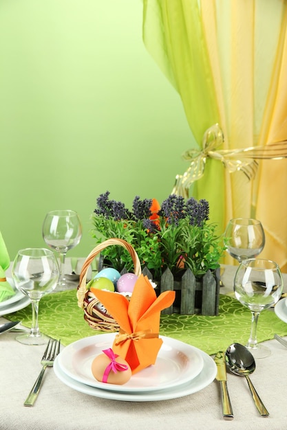 Easter table setting on color background