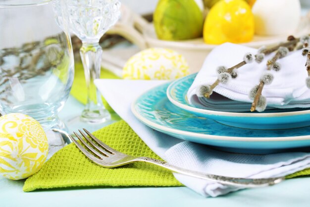 Easter table setting on color wooden background