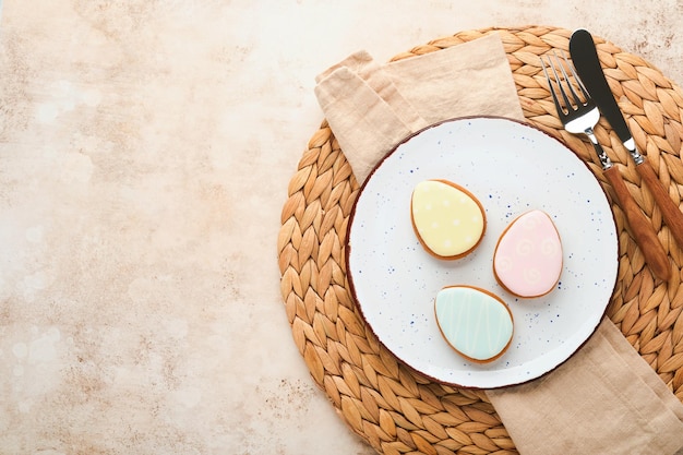 Easter table setting Easter dinner with multicolored easter eggs Elegance pastel and beige tablescapes View from above Christian religion tradition Happy Easter concept Mock up