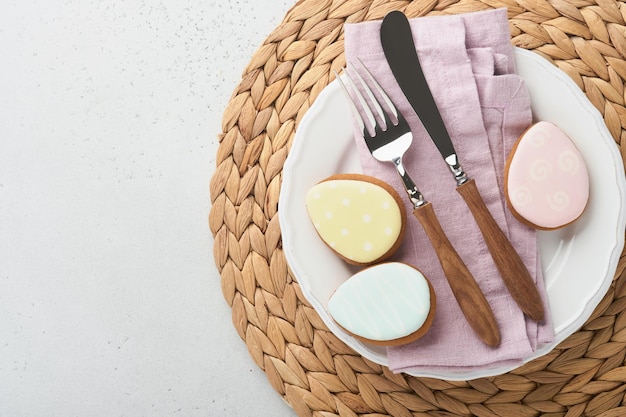 Easter table setting Easter dinner with multicolored easter eggs Elegance pastel and pink tablescapes View from above Christian religion tradition Happy Easter concept Mock up