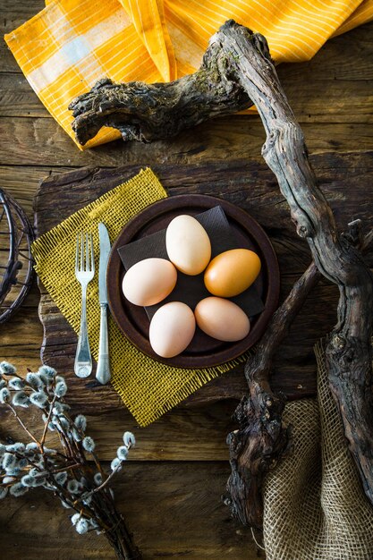 Photo easter table setting fresh eggs on plate spring table
