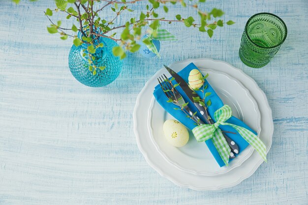 Easter table setting with painted eggs and cutlery