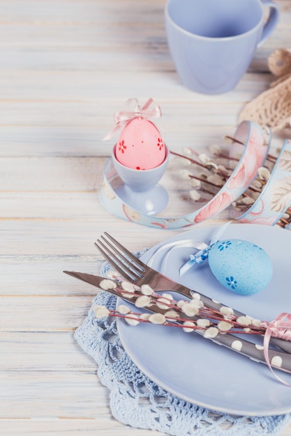 Easter table setting with willow branches and cutlery