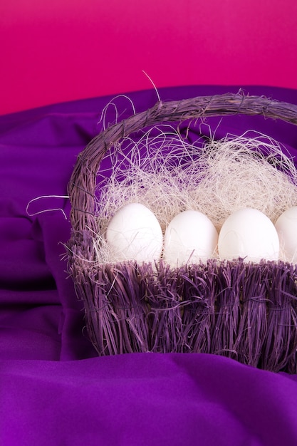 Easter. White eggs in purple basket