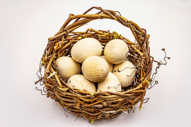 Easter wicker basket isolated on white background. Zero waste, DIY concept. Wooden eggs