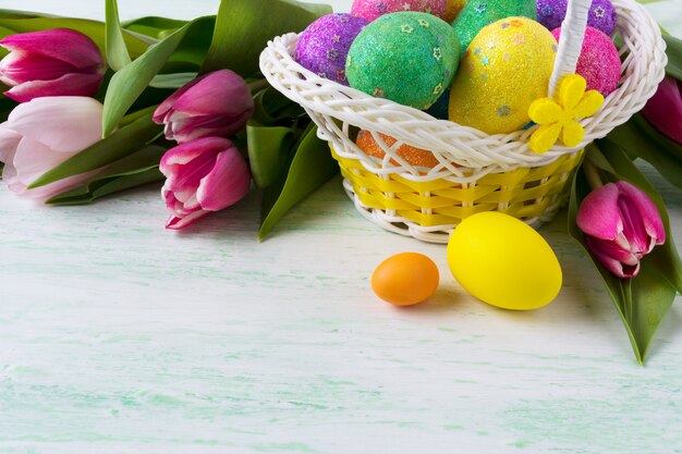 Easter wicker basket with multicolored eggs