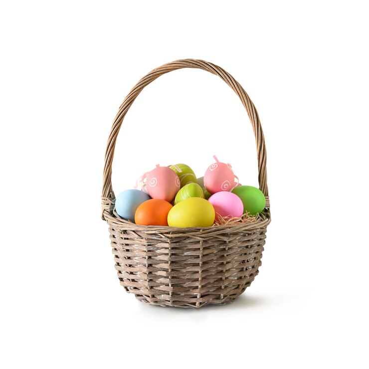 Photo easter wicker basket with pastel colorful eggs on white