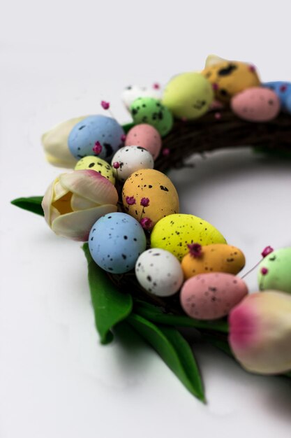 Easter wreath of decorative quail eggs and tulips. Top view of the rattan wreath. Easter decor