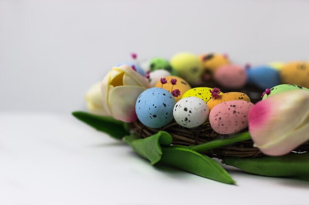 Easter wreath of decorative quail eggs and tulips Top view of the rattan wreath Easter decor