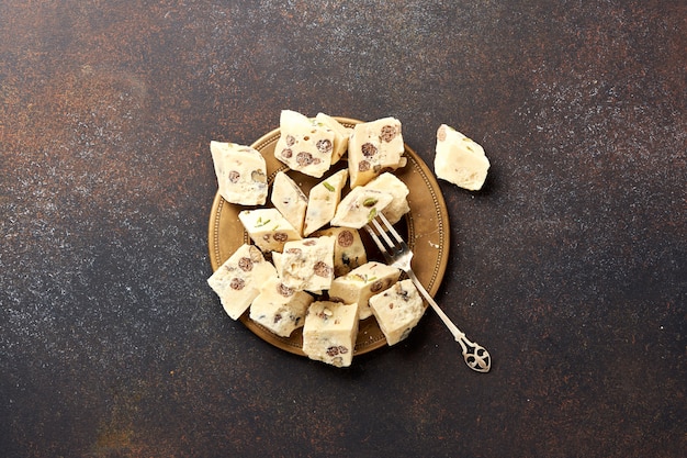 Eastern delicacy. Halva, sweetness, dessert on brown background.