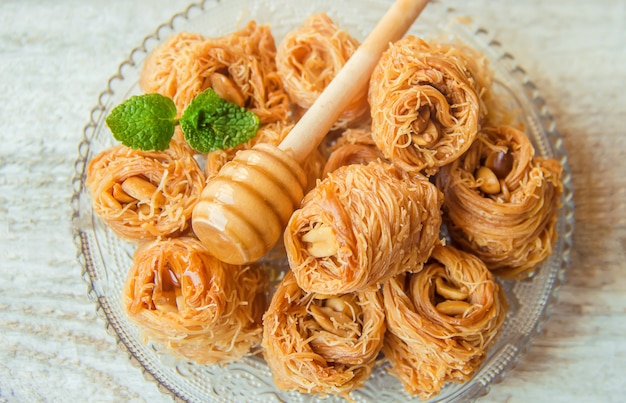 Eastern sweetness, baklava with peanuts and honey. Isolate. Selective focus.