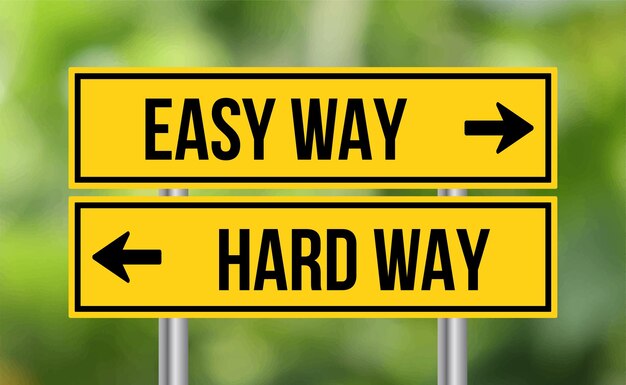 Easy way or hard way road sign on blur background