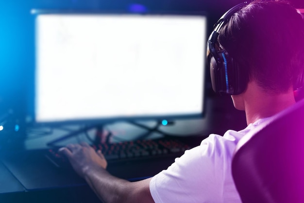 Eat, game, sleep. Rearview shot of a man playing computer games.