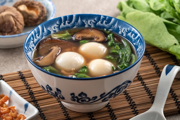 Eating big tangyuan yuanxiao with savory soup in Taiwan