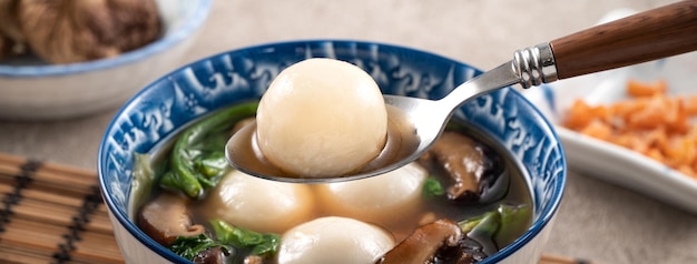 Eating big tangyuan yuanxiao with savory soup in Taiwan