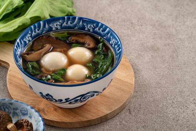 Eating big tangyuan yuanxiao with savory soup in Taiwan