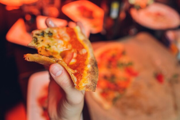 Eating Pizza. Group Of Friends Sharing Pizza Together. People Hands Taking  Slices Of Pepperoni Pizza. Fast Food, Friendship, Leisure, Lifestyle. Stock  Photo