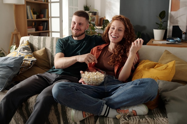 eating popcorn and watching comedy