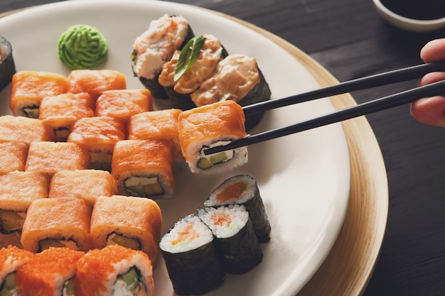 Eating sushi rolls at Japanese food restaurant