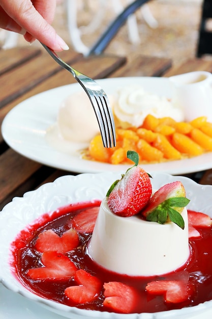 eatting delicious italian dessert panna cotta 