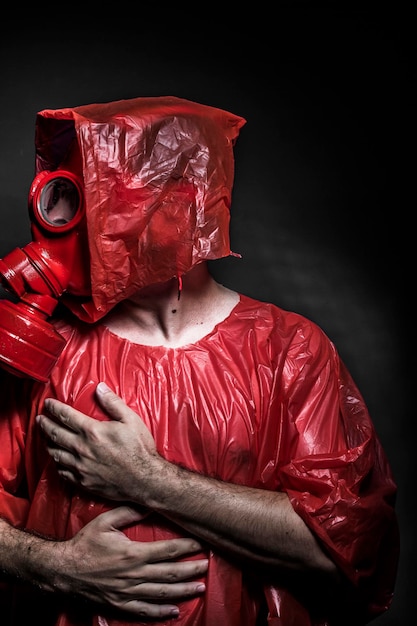 Ebola infection concept, man with red gas mask