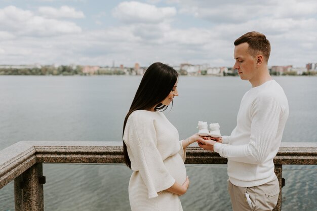 Echtgenoot en zwangere vrouw die babyschoenenclose-up houden