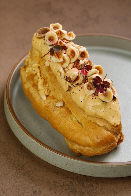 Eclair served with fried hazelnuts