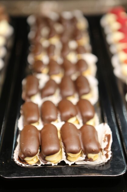 Photo eclairs with chocolate topping delicious chocolate small cake ekler pastry