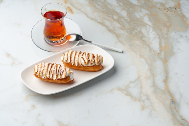 Eclairs with cream decorating of Swiss meringue frosting