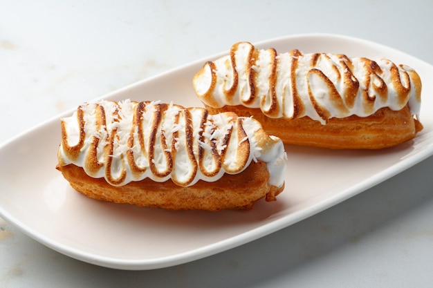 Eclairs with cream decorating of swiss meringue frosting