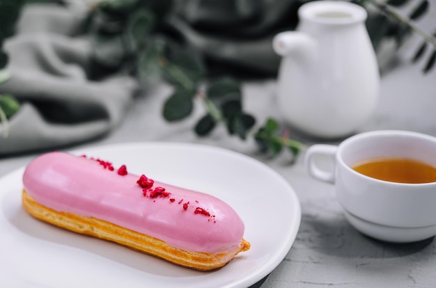 Eclairs with glaze on a white plate
