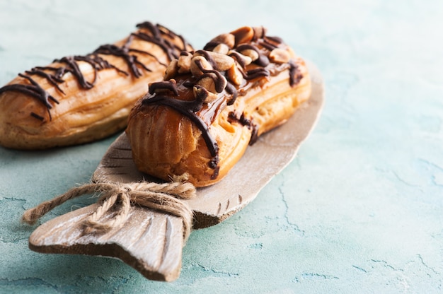 Eclairs with peanuts, chocolate icing 