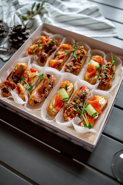 Eclairs with salmon fresh vegetables and herbs gourmet snacks