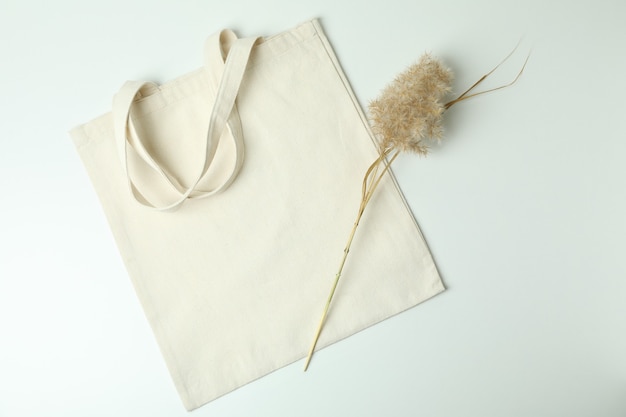 Eco bag and reeds on white background