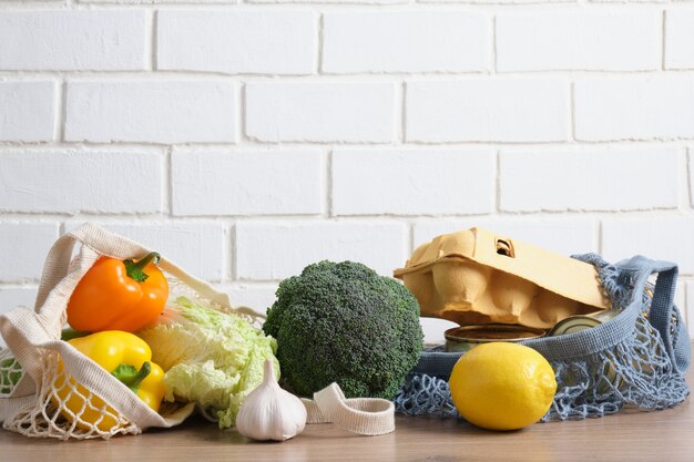 Eco bag with food on a wooden kitchen table