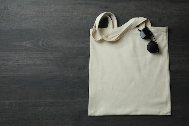 Eco bag with sunglasses on dark textured