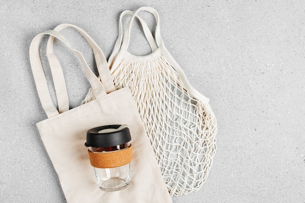 Eco bags and reusable coffee mug. Sustainable lifestyle. Plastic free concept.