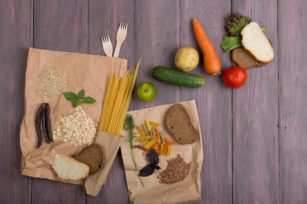 Eco bags with products rich of complex carbohedrates cereals bread pasta and vegetables