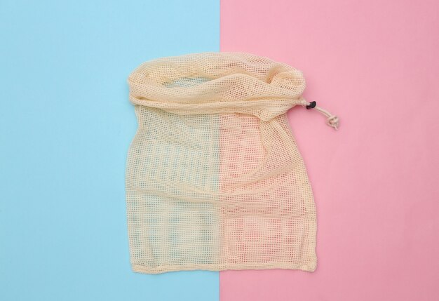 Eco cotton bag on pink blue pastel background. Top view