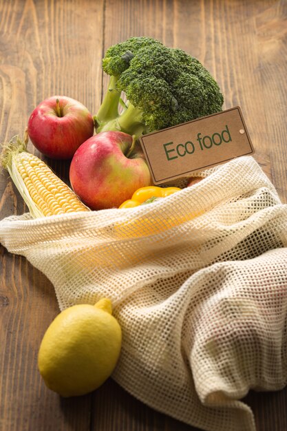 Eco food concept. Full mesh bag of different health food on wooden table