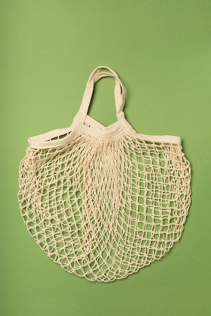 Eco-friendly bag, string bag on a green surface