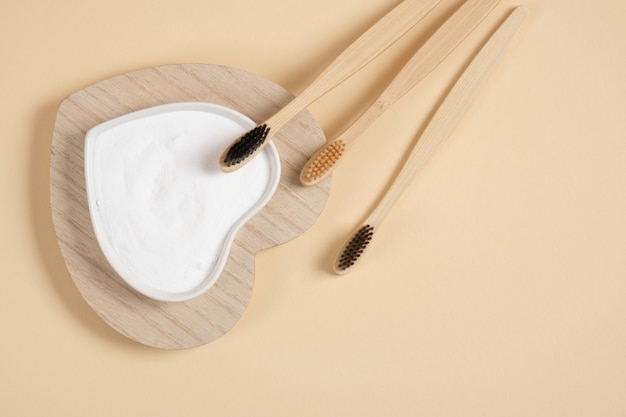 Eco-friendly bamboo teethbrush. bamboo toothbrushes and baking soda on beige background zero waste life style concept. brushing your teeth with soda