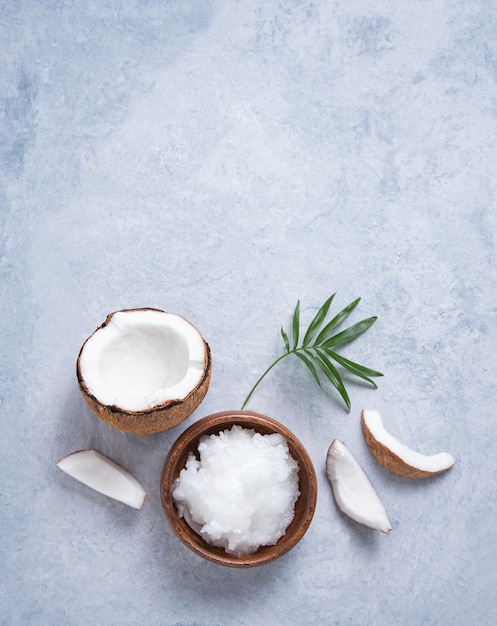 Eco friendly flat lay Fresh coconut oil and coconut slices  on blue  background